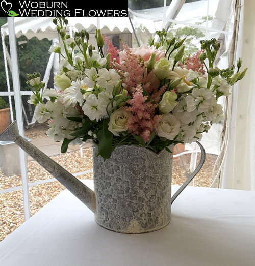 Stocks, Astilbe, Lizzianthus and Rose arrangement in watering can.