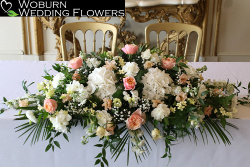 Coral and white registrars table arrangement.