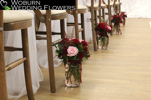 Aisle vases of pink and red Roses with Astilbe.