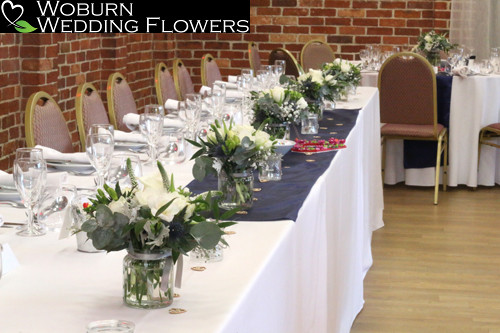 Top Table mini vases of White Rose, Thistle and Babys Breath.