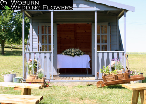 Wedding Hut with rustic flower arrangements.