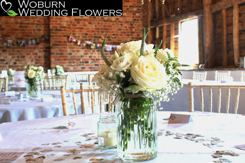 Ivory and white vase including Roses, Babys Breath and Veronica.