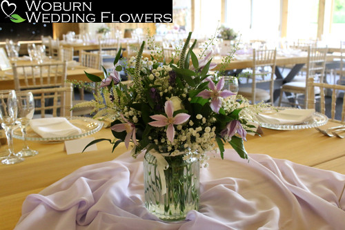 Soft vase design in lilacs and whites including Clematis and Lavender.