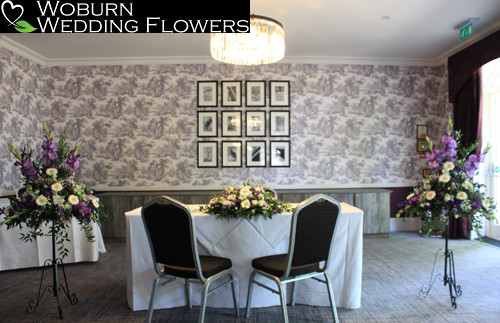 Registrars arrangement and matching pedestals with gerbera, gladioli, clematis and lisianthus